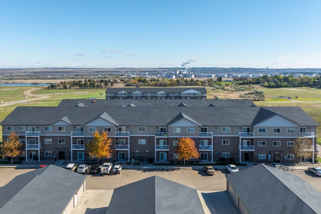 A large building with a parking lot in front of it.