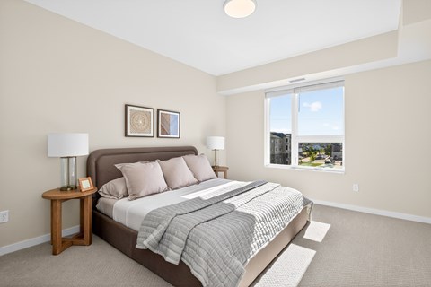 A bedroom with a large bed and a window overlooking a cityscape.