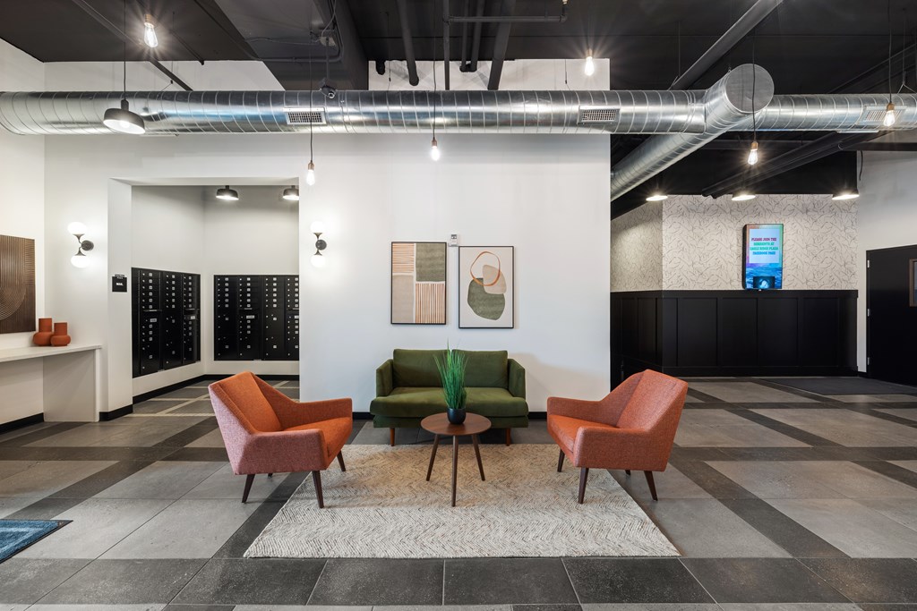 A room with a white wall and a green couch.