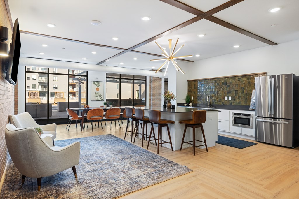 A modern kitchen with a dining table and chairs.