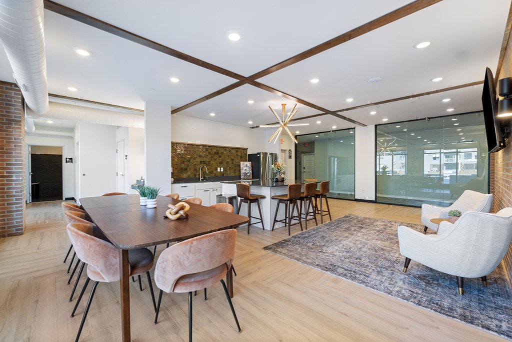 A modern dining room with a wooden table and chairs.