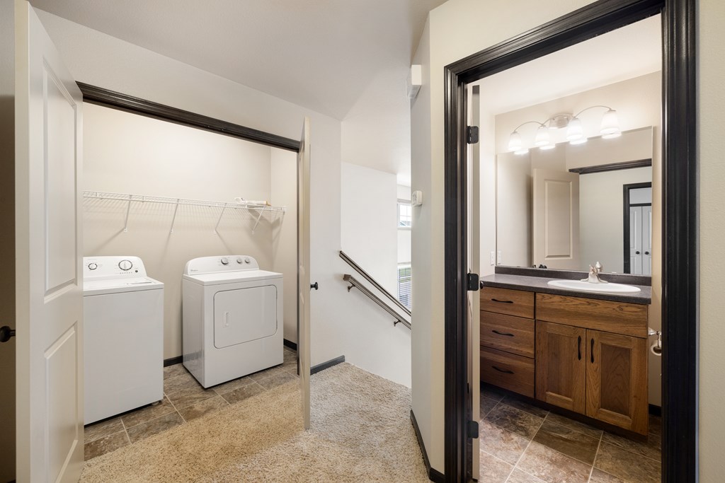A bathroom with a washer and dryer in it.