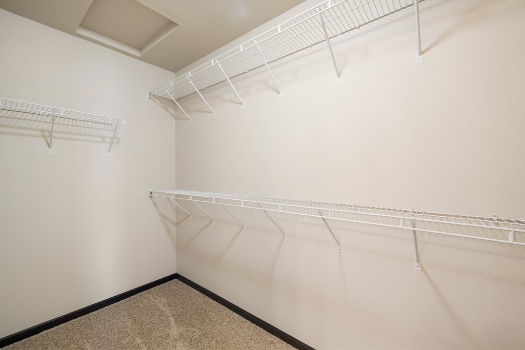 Empty white shelves in a room.