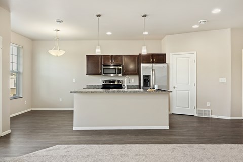 A kitchen with a white counter and brown cabinets.