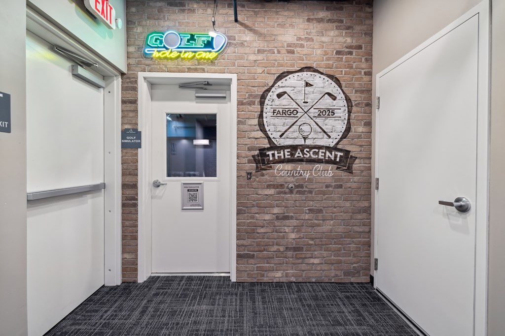 A door with a sign next to it that says The Ascent Clubhouse