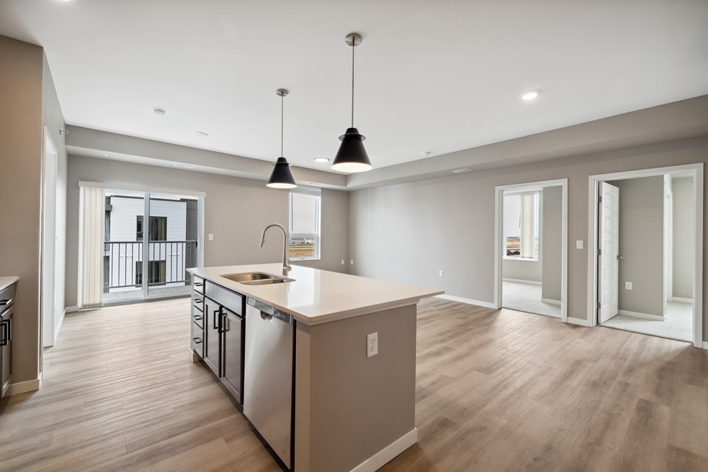 A kitchen with island and brown cabinets.