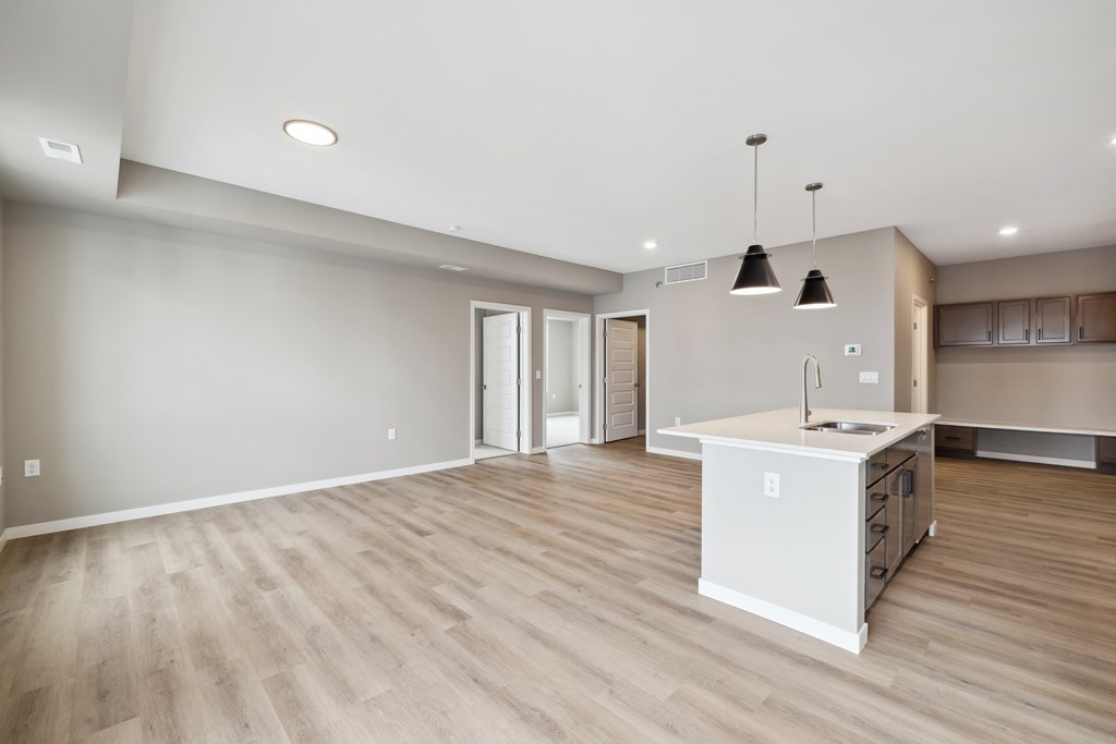 A kitchen with island and brown cabinets.
