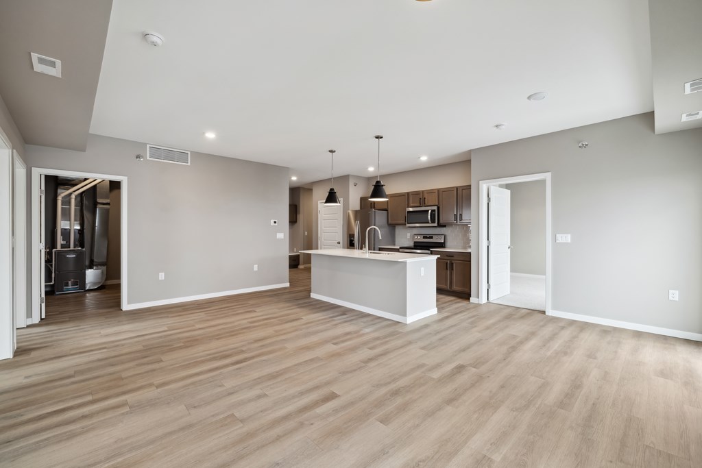 A kitchen with island and brown cabinets.