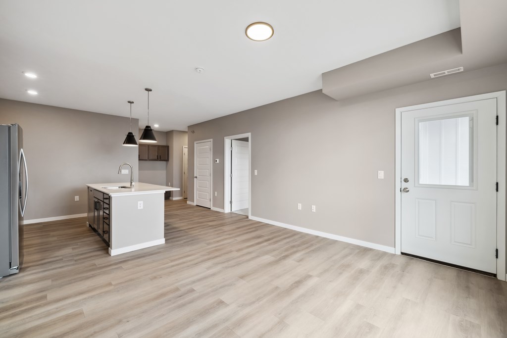 A kitchen with island and brown cabinets.