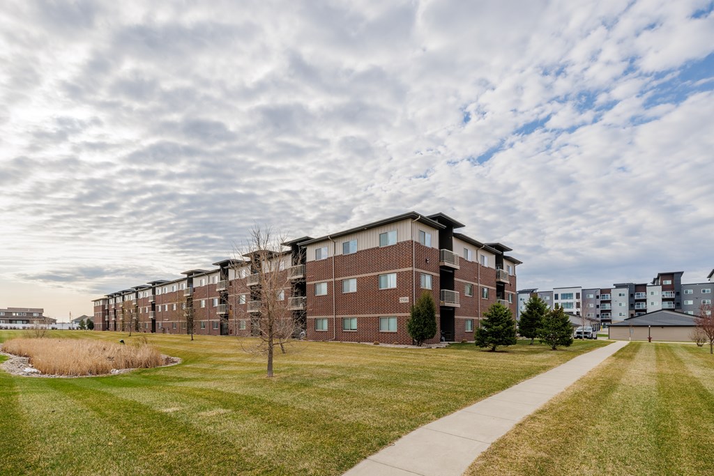 A long building with a walkway in front of it.