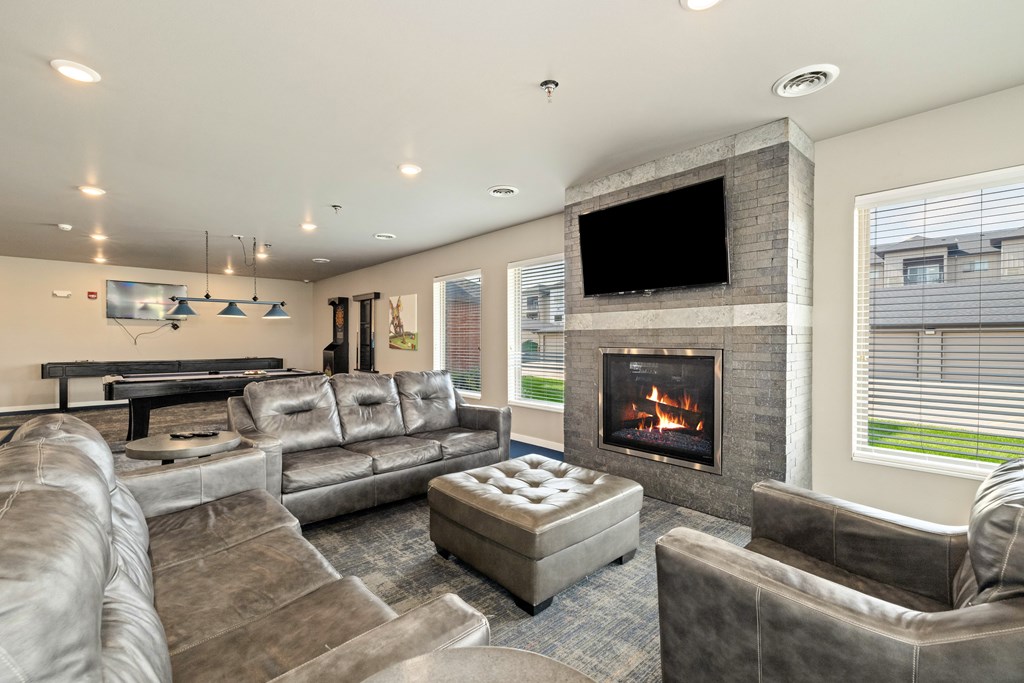 A modern living room with a fireplace and a television.