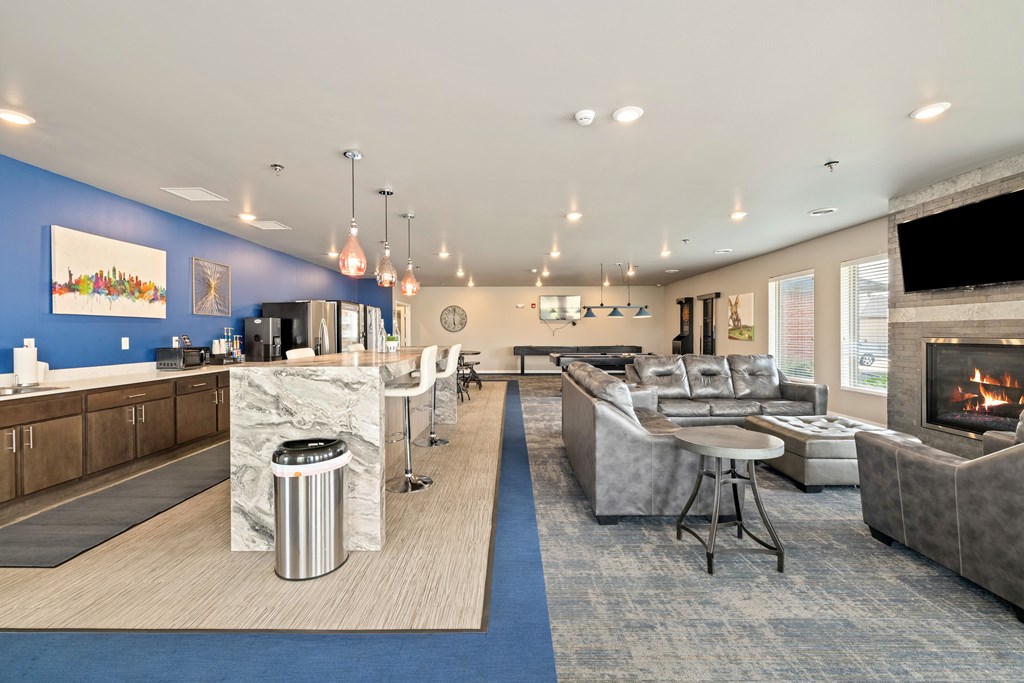 A modern living room with a fireplace and a blue accent wall.