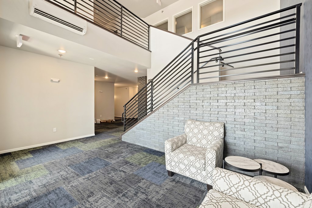 A room with a staircase and a chair.