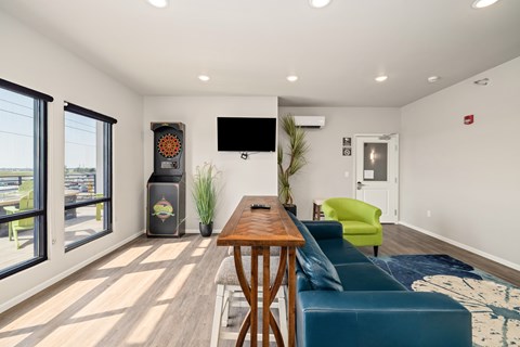 A modern living room with a wooden table and blue couch.