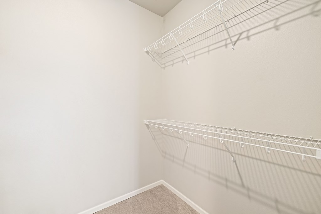 Empty white closet with shelves.