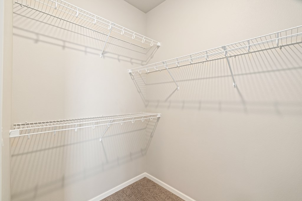 Empty white shelves in a room.