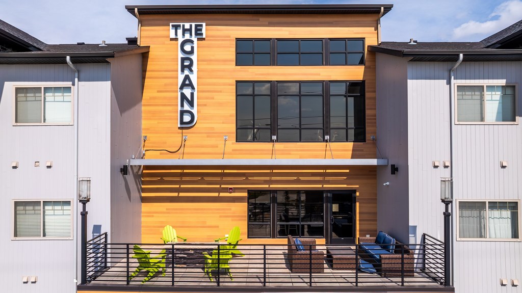 The Grand building with a balcony in front.