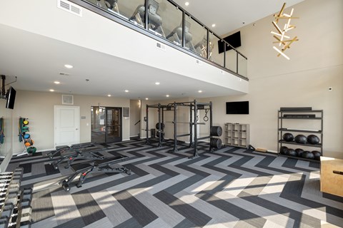 A spacious gym with a variety of equipment and a checkered floor.