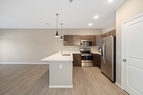 A modern kitchen with a white island and stainless steel appliances.
