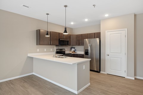 A kitchen with a white countertop and stainless steel appliances.