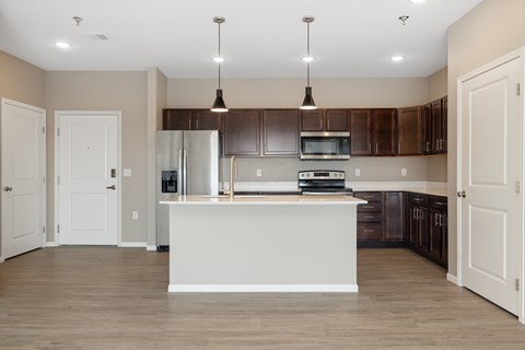 A kitchen with a white island in the middle of it.