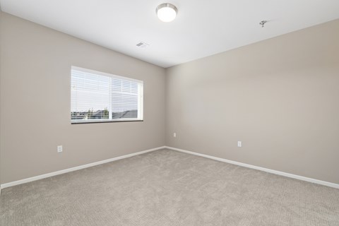 A room with a window and a ceiling light.