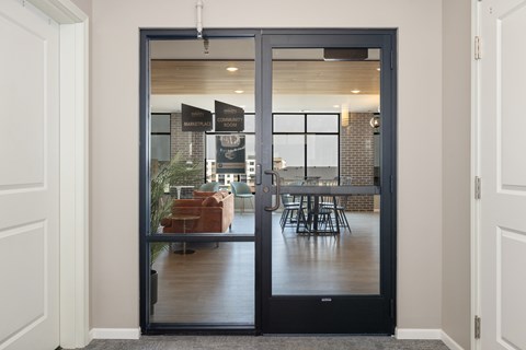 A glass door with a handle and a sign on it.