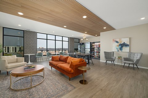 A modern living room with a wooden ceiling and a large window.