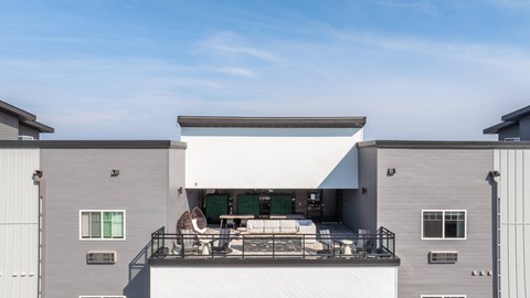 A modern house with a balcony and a white awning.