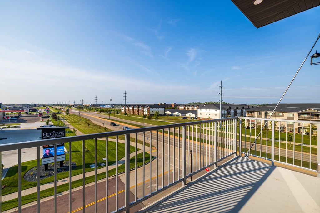 A view from a balcony overlooking a road with a sign that reads "HENRY'S".