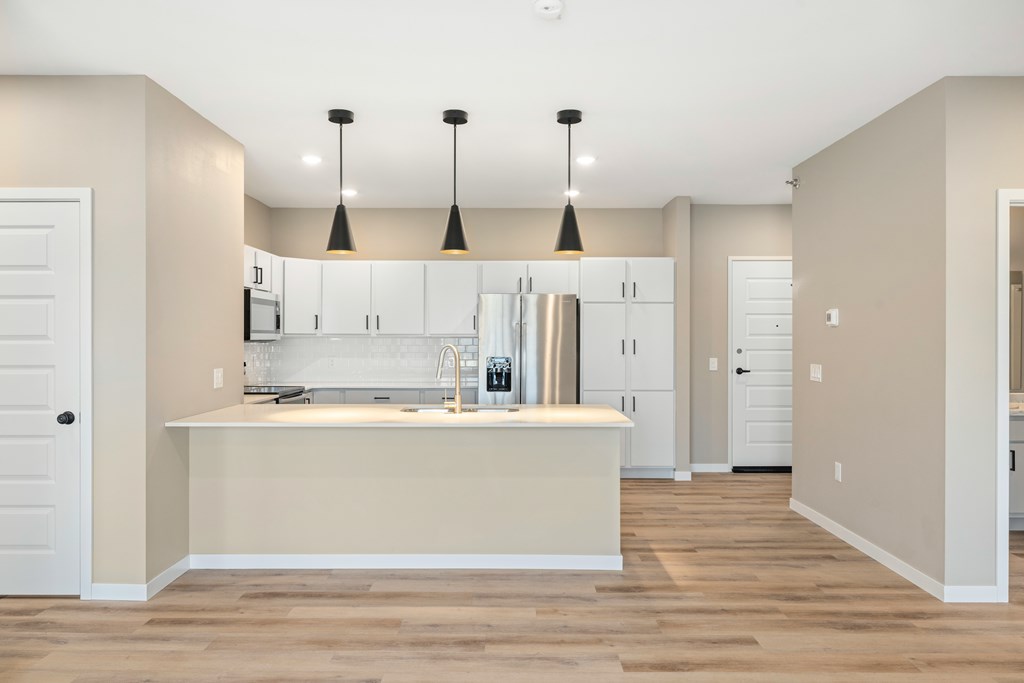 A kitchen with a white counter and cabinets.