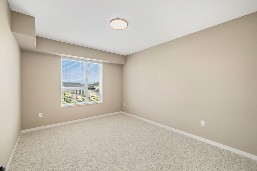 A room with a window overlooking a cityscape.