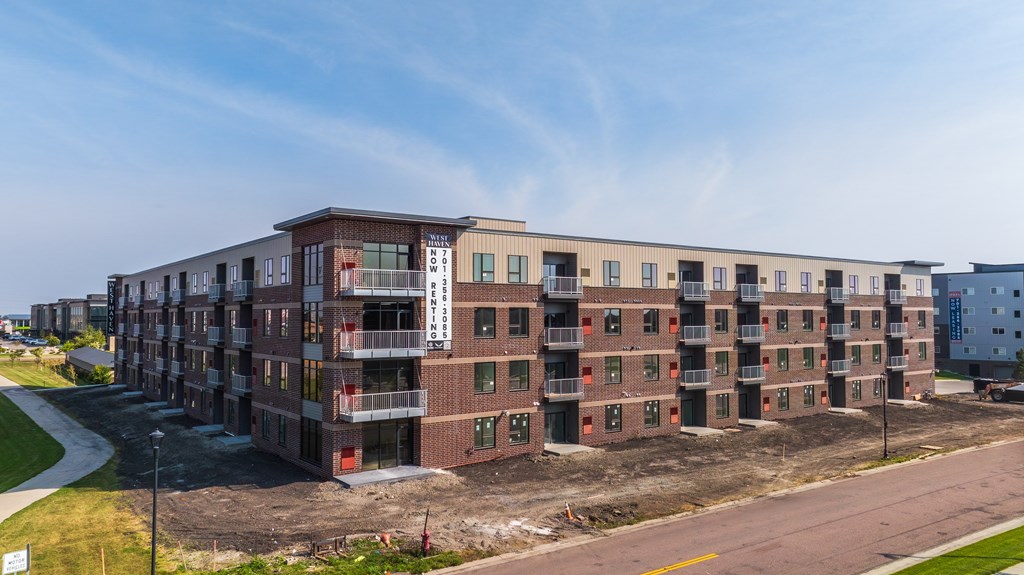 A large building under construction with a clear blue sky above.