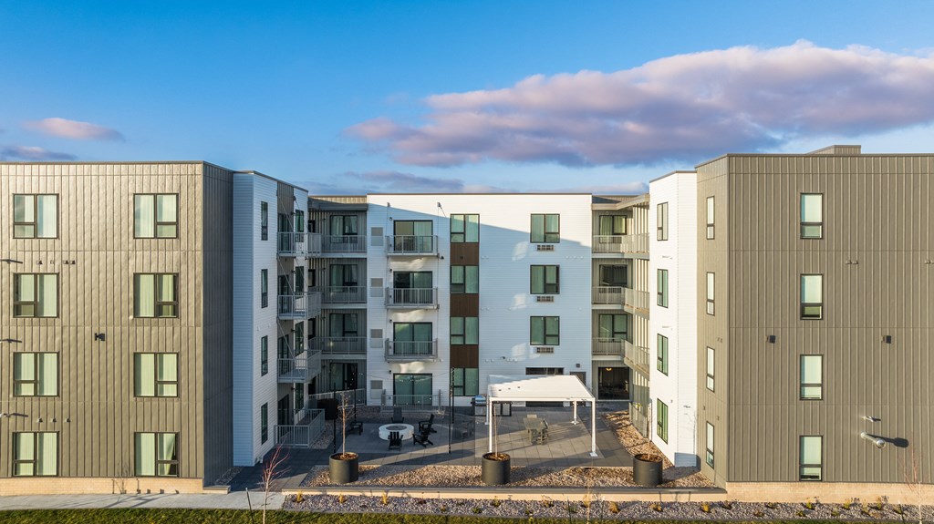 an image of an apartment building with a blue sky in the background