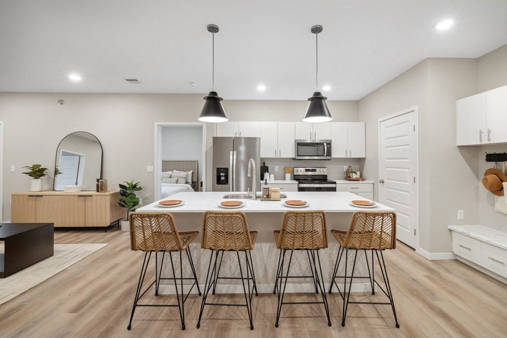 a large dining room with tables and chairs and white walls