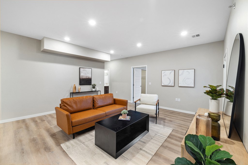 a living room with a leather couch and a coffee table