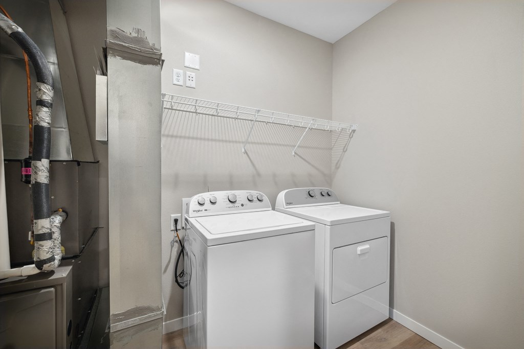 an empty laundry room with two washes and a dryer in a rental apartment