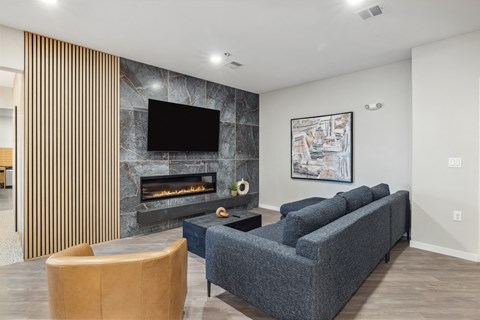 a living room with a couch and a chair and a fireplace