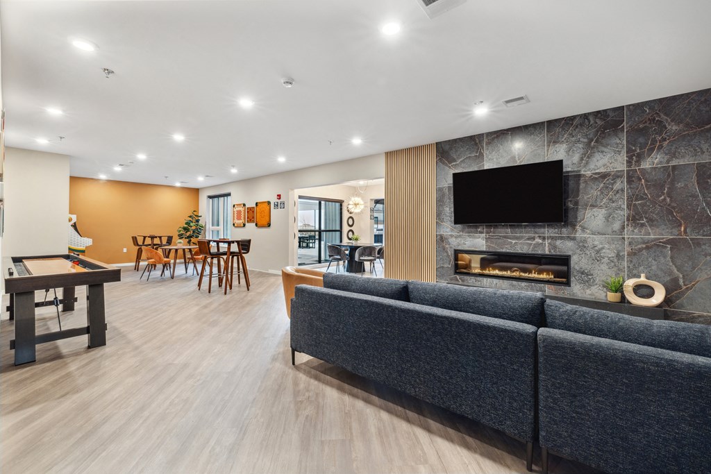 a living room with a fireplace and a table and chairs