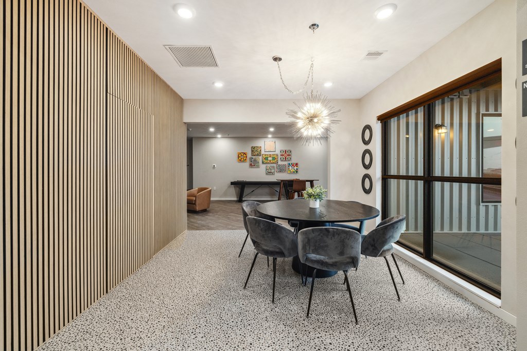 a dining room with a table and chairs and a large window