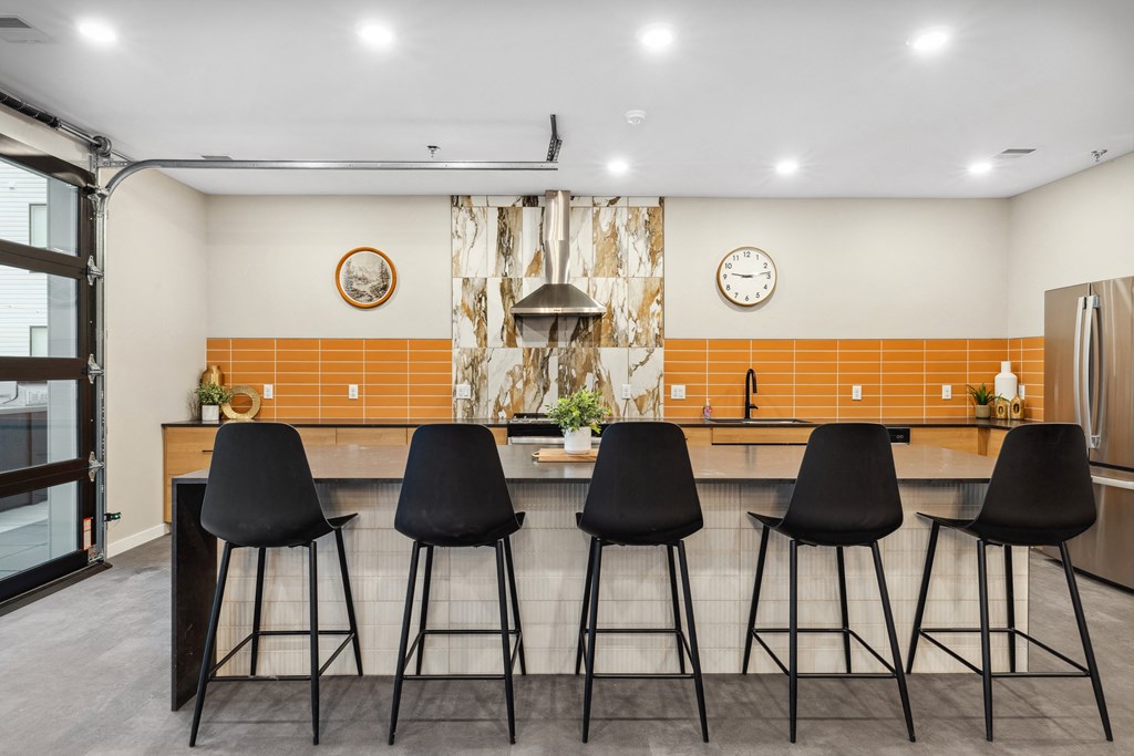 a kitchen with a counter top and bar stools