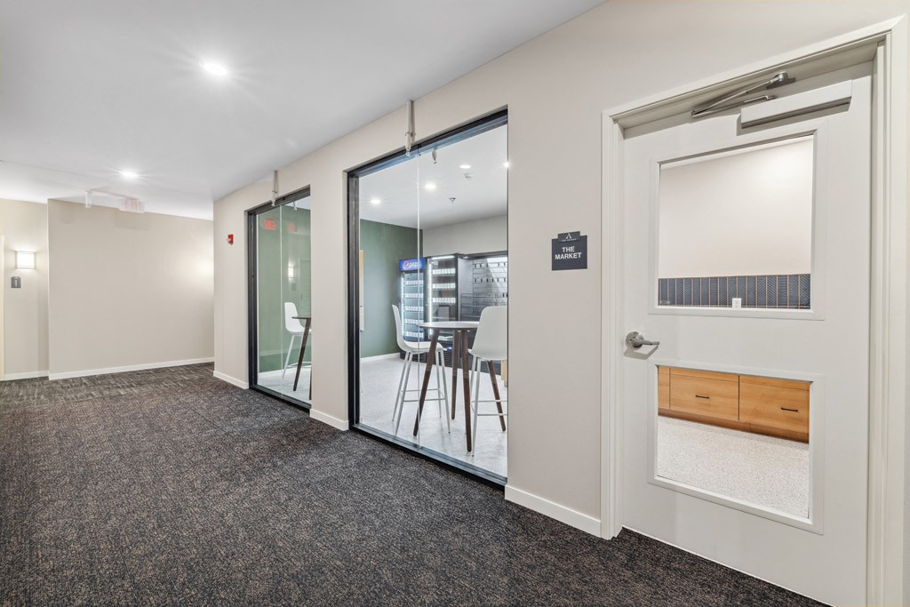 a conference room with glass doors and a table and chairs