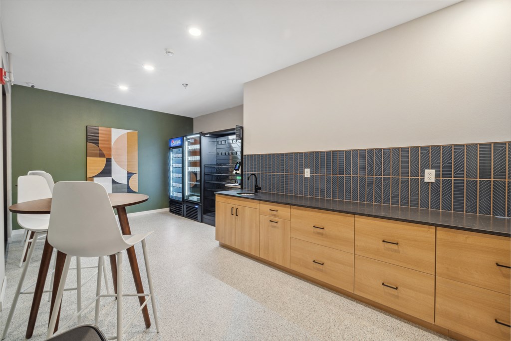 a kitchen with a table and chairs and a refrigerator