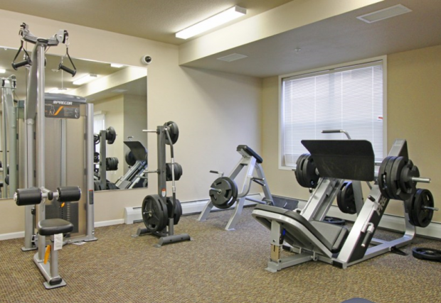 a gym with exercise equipment and a window