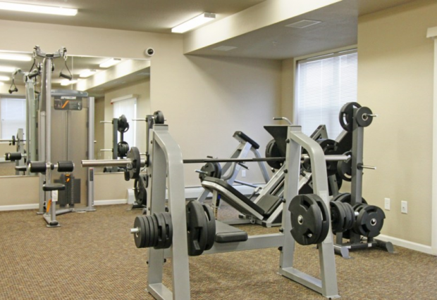 a fitness room with weights and other exercise equipment