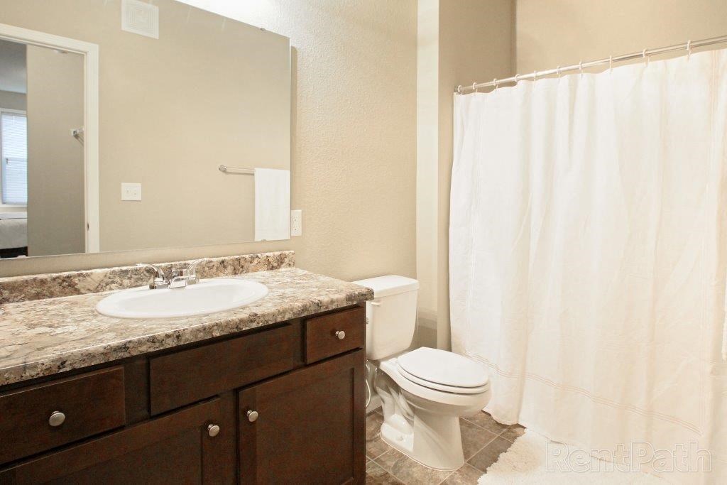 a bathroom with a sink toilet and a shower