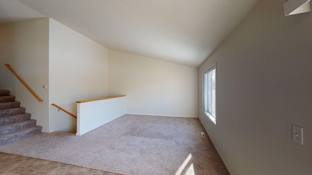 A room with a staircase and a window.