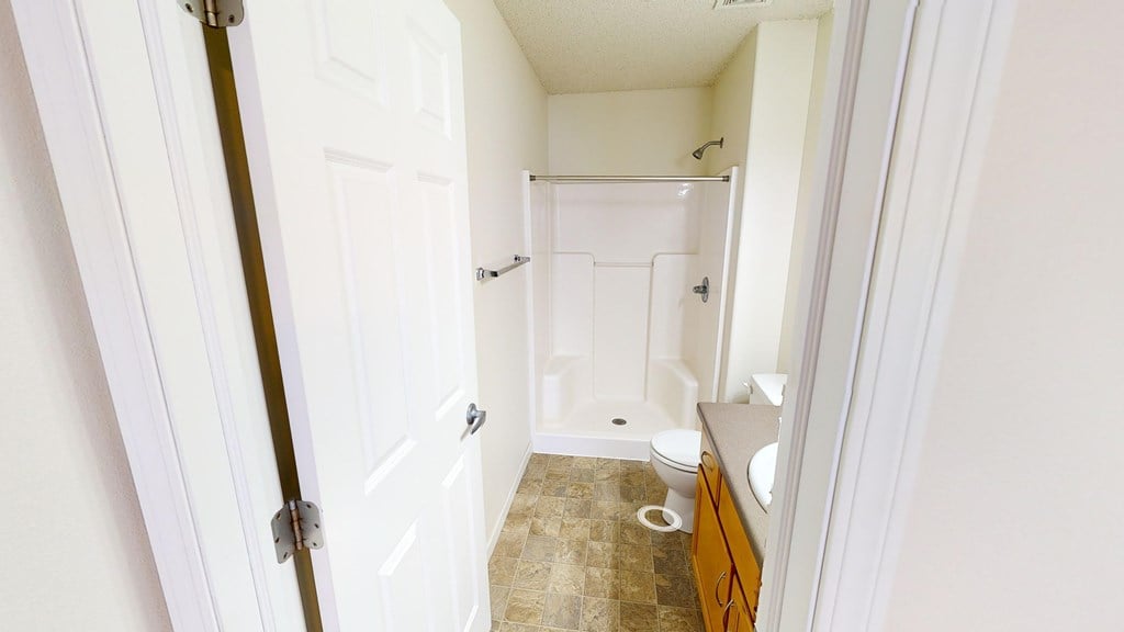 A bathroom with a toilet, sink, and bathtub.