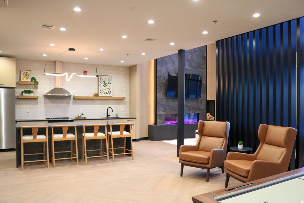A modern kitchen with a bar area and seating.