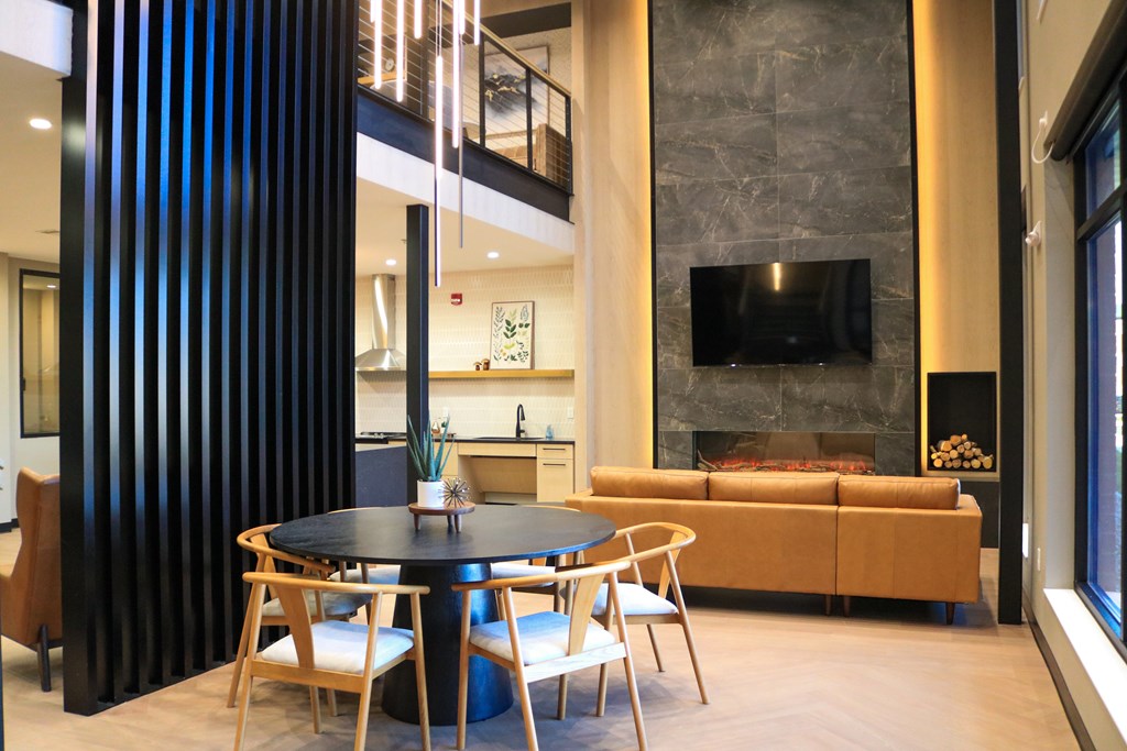 A modern living room with a fireplace and a TV mounted on the wall.